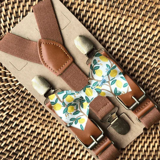 Size chart for suspender and bow tie sets from The Bold Bow Tie. X-Small (6mo-4yr): 15"-23" suspenders, 3.5" bow. Small (5-9yr): 18"-33" suspenders, 3.5" bow. Medium (10-12yr): 18"-33" suspenders, 4" bow. Adult (13yr-6'5"): 30"-53" suspenders, 4.5" bow. Big & Tall (Over 6'5"): 53"+ suspenders, 4.5" bow. Instructions note to measure from the back waistband over the shoulder to the front waistband for a comfortable fit.
