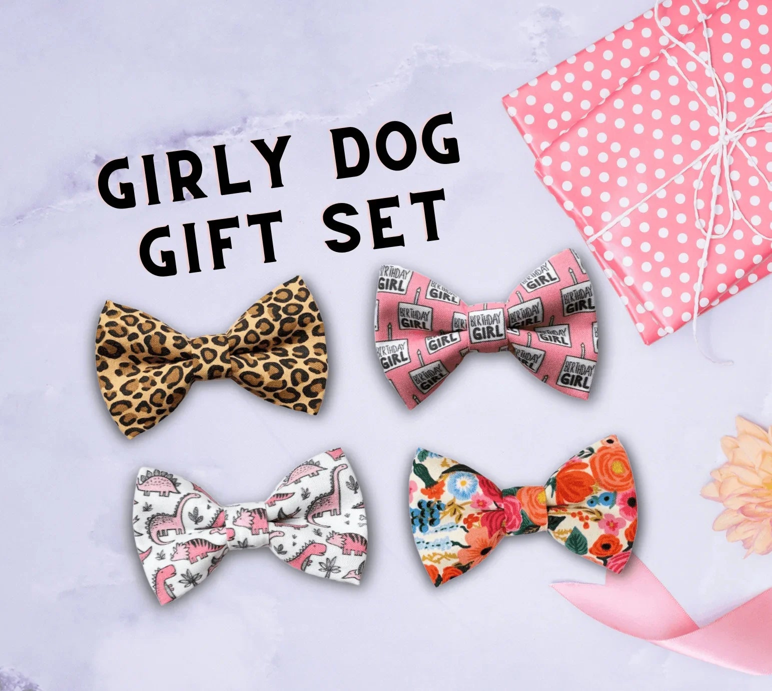 Assorted girly dog and cat bows arranged on a lavender background with a pink polka dot gift box