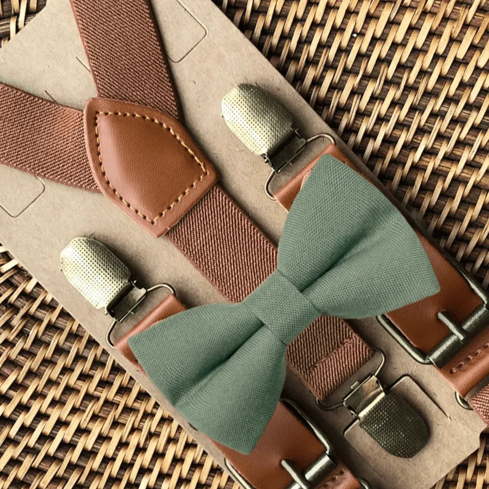 Size chart for suspender and bow tie sets from The Bold Bow Tie. X-Small (6mo-4yr): 15"-23" suspenders, 3.5" bow. Small (5-9yr): 18"-33" suspenders, 3.5" bow. Medium (10-12yr): 18"-33" suspenders, 4" bow. Adult (13yr-6'5"): 30"-53" suspenders, 4.5" bow. Big & Tall (Over 6'5"): 53"+ suspenders, 4.5" bow. Instructions note to measure from the back waistband over the shoulder to the front waistband for a comfortable fit.