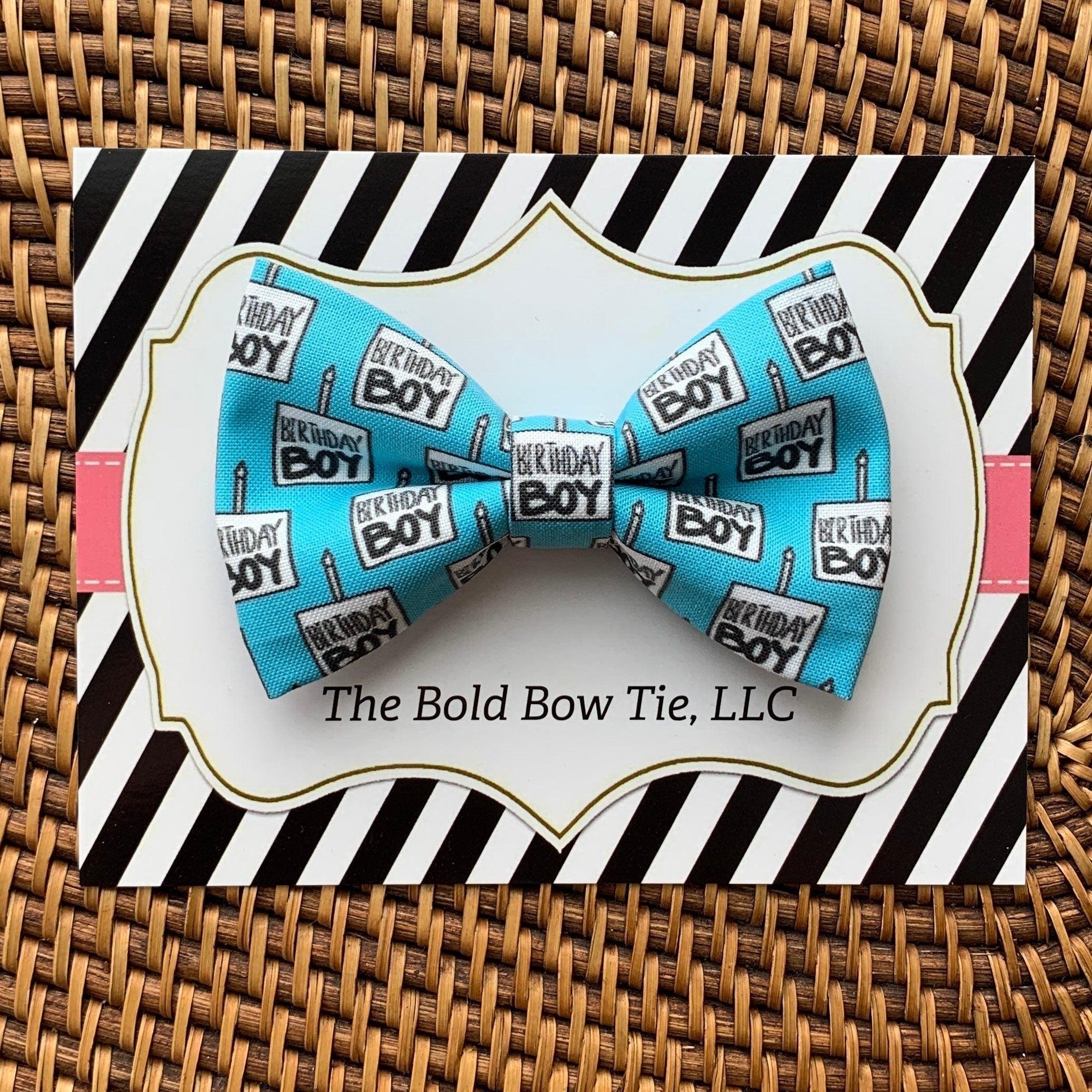 Blue bone pattern bow tie placed on a black and white striped gift card from The Bold Bow Tie LLC