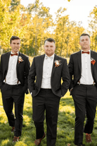 Groomsmen in burnt orange floral bow tie.