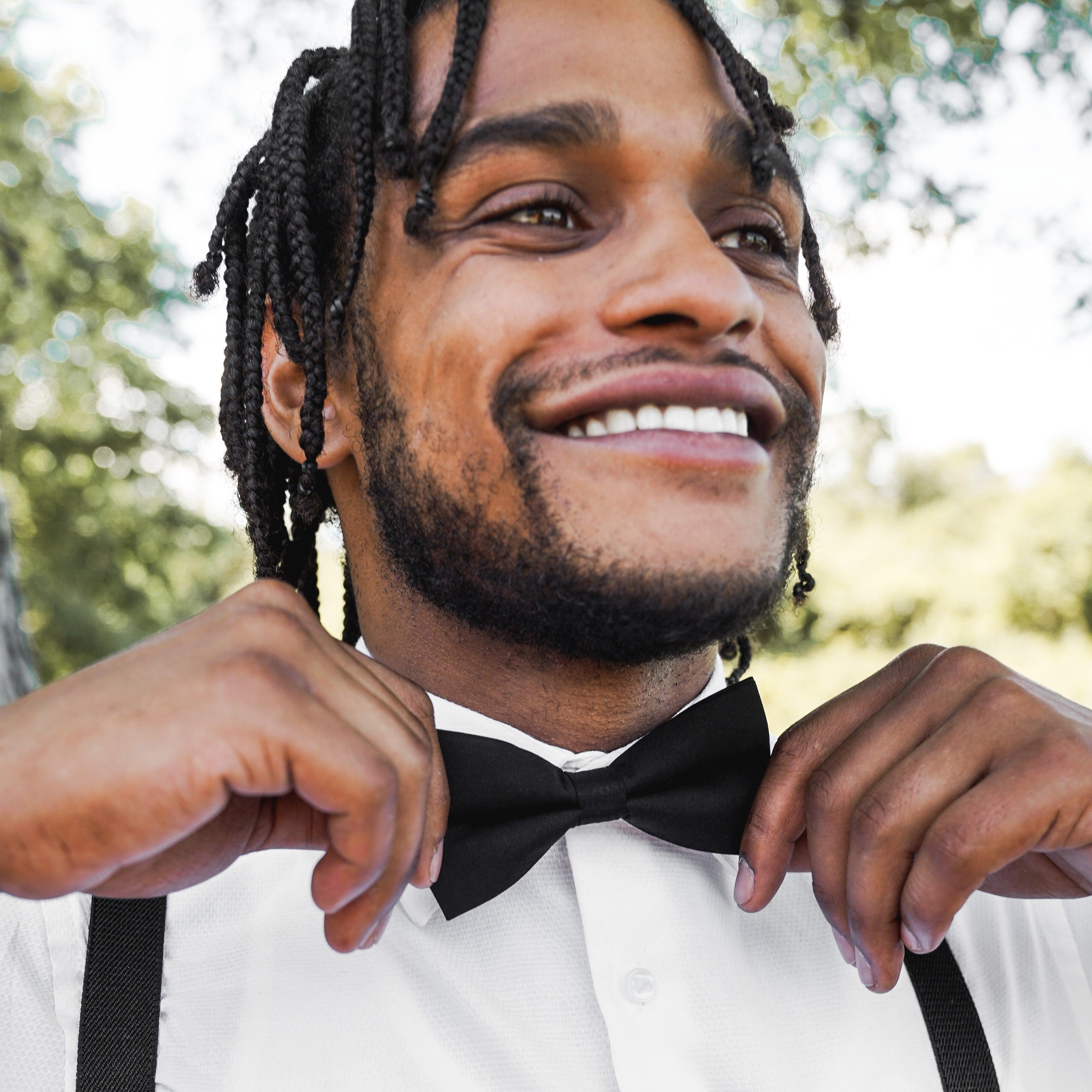Black Bow Tie and Black & Gold Suspenders Set for wedding worn by a groomsman.