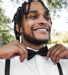 Black Bow Tie and Black & Gold Suspenders Set for wedding worn by a groomsman.