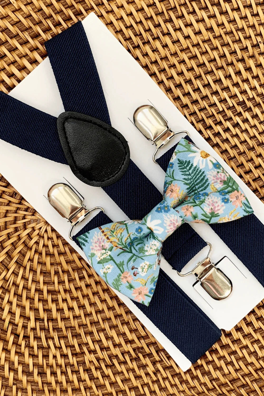 Size chart for suspender and bow tie sets from The Bold Bow Tie. Small (6mo-6yr): 18"-29" suspenders, 3.5" bow. Medium (7-12yr): 25.5"-40" suspenders, 4" bow. Adult (13yr-6ft tall): 25.5"-40" suspenders, 4.5" bow. Big & Tall (Over 6ft tall): 31"-53" suspenders, 4.5" bow. Instructions note to measure from the back waistband over the shoulder to the front waistband for a comfortable fit.