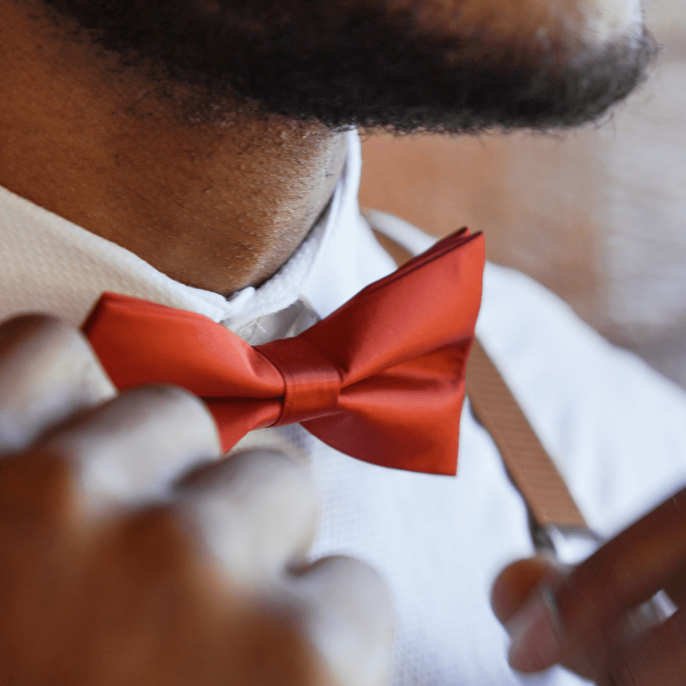 Groomsmen in burnt orange bow tie.