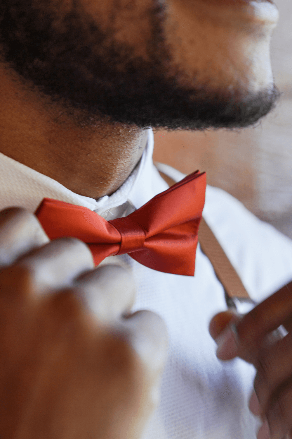 Groomsmen in burnt orange bow tie.