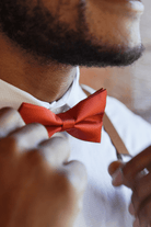 Groomsmen in burnt orange bow tie.