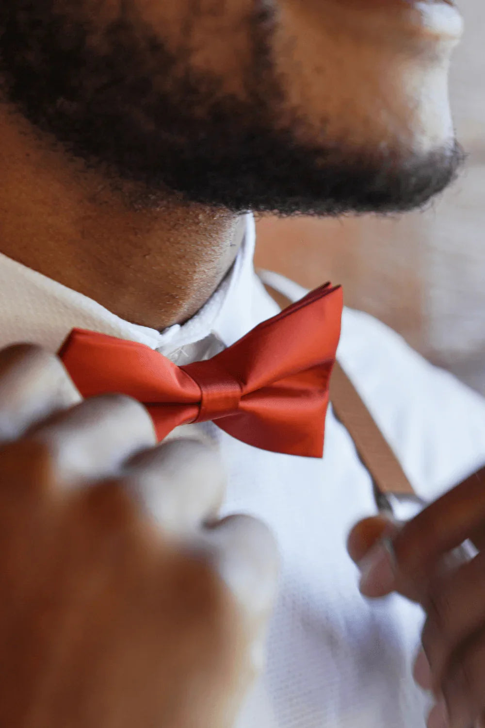 Groomsmen in burnt orange bow tie.