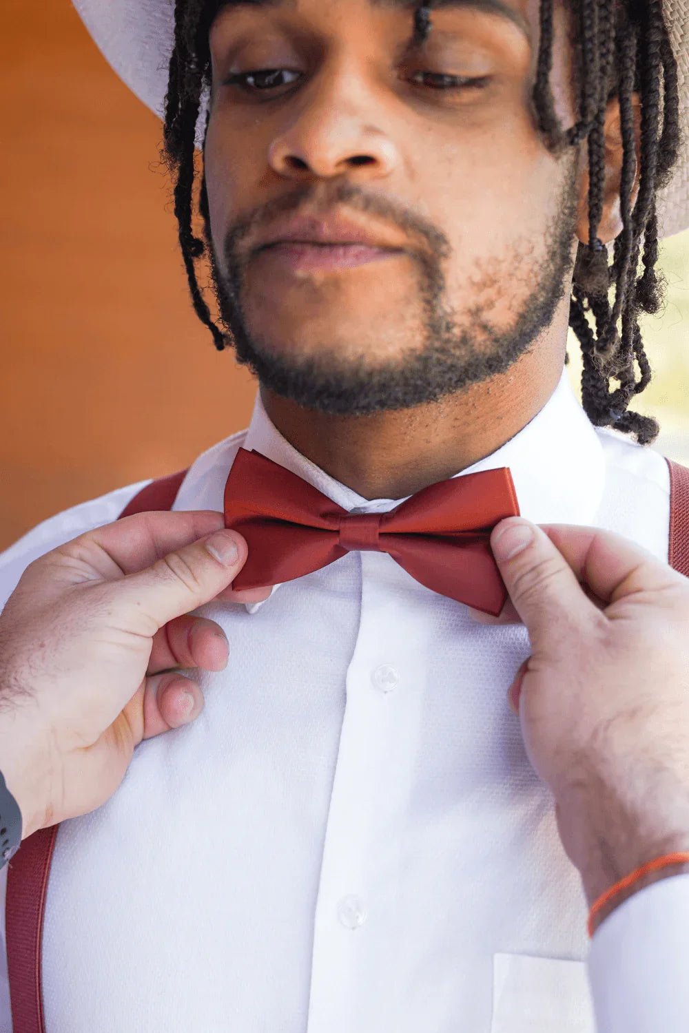 Size chart for pre-tied bow ties from The Bold Bow Tie detailing measurements across three sizes. Small is 3.5 inches wide and recommended for ages 6 months to 5 years. Medium is 4 inches wide and recommended for ages 6 to 12 years. Large is 4.5 inches wide and recommended for ages 13 years and up. Visual icons illustrate the relative sizes with horizontal arrows showing that width is measured from wingtip to wingtip. Bottom text notes that all bow ties are pre-tied and ready to add to your outfit.