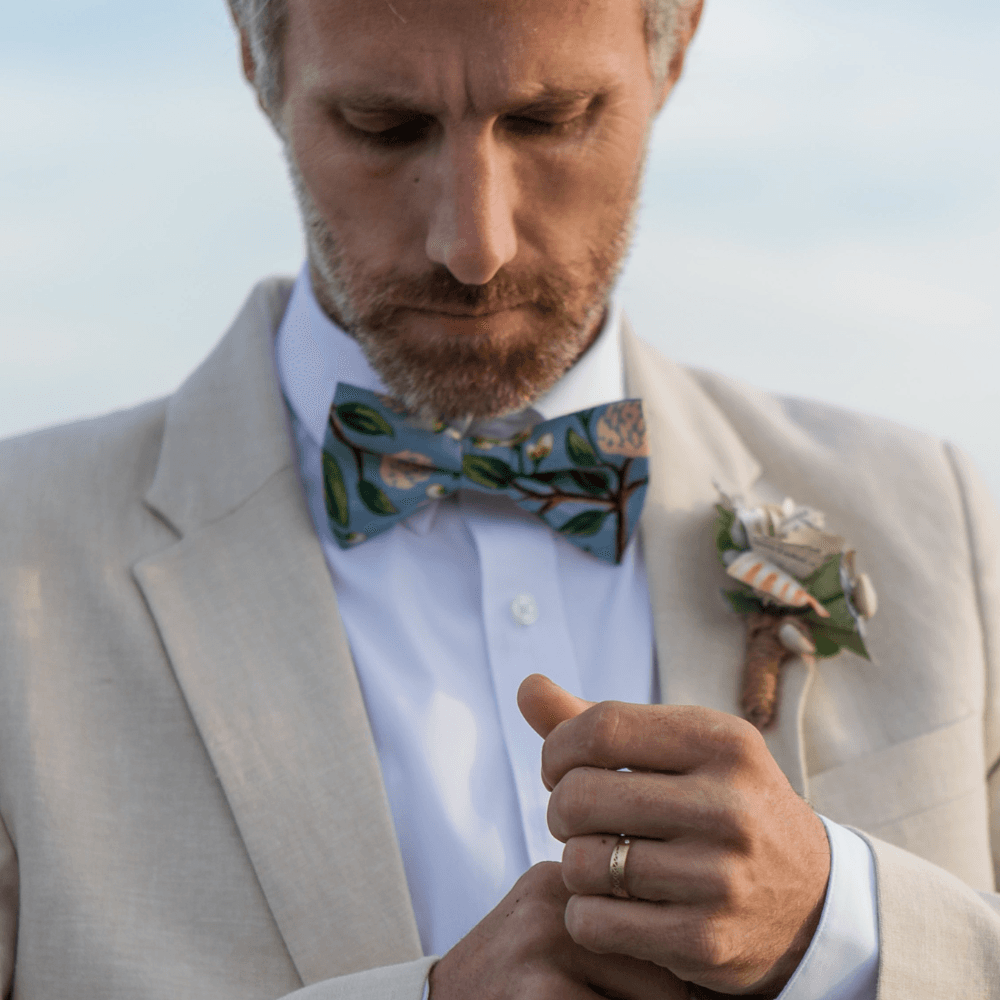 Groom wearing a dusty blue hydrangea bow tie