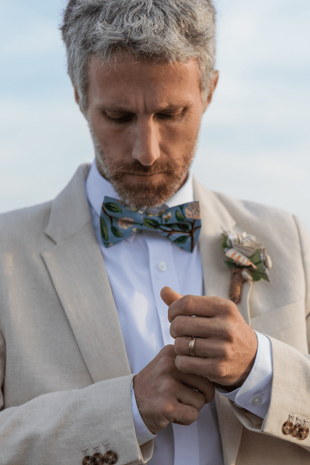 Groom wearing a dusty blue hydrangea bow tie