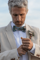 Groom wearing a dusty blue hydrangea bow tie