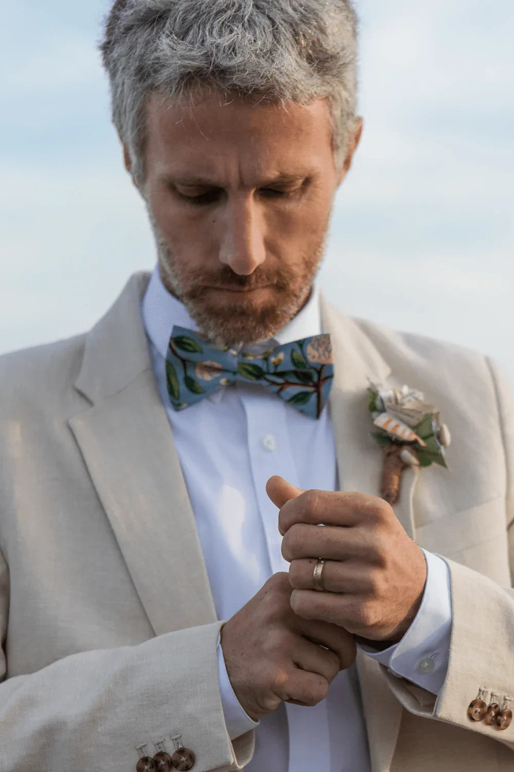 Groom wearing a dusty blue hydrangea bow tie