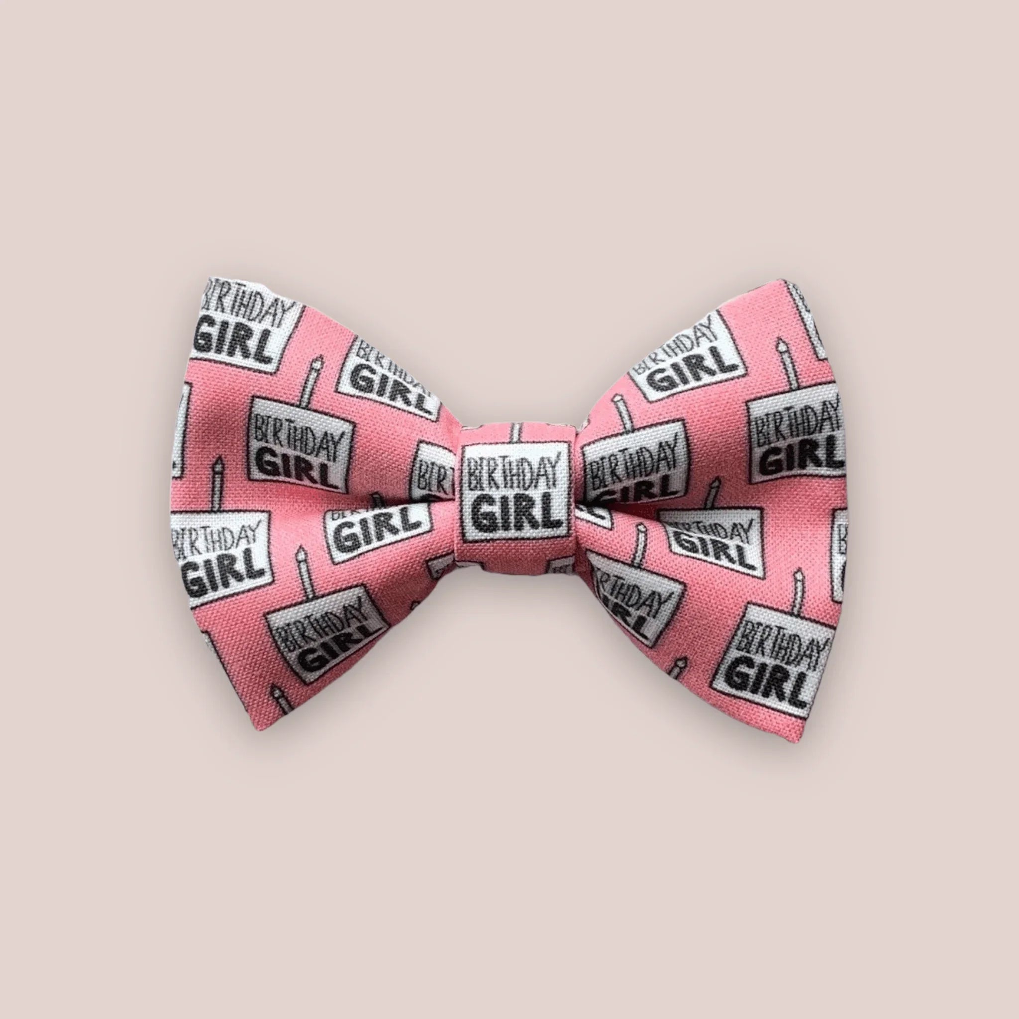 Pink birthday girl hair bow with repeating birthday girl text pattern.