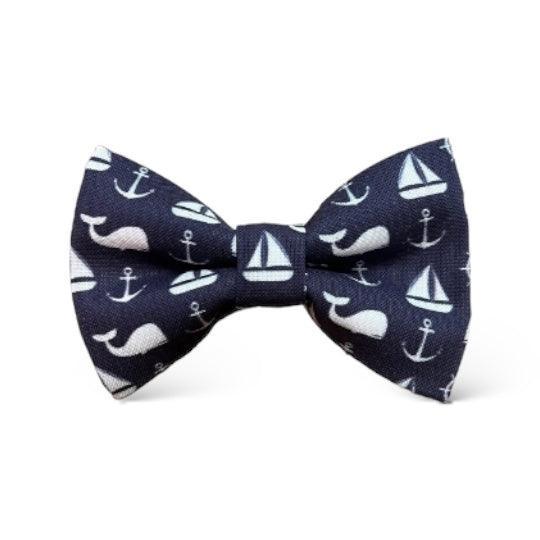 Size chart for pre-tied bow ties from The Bold Bow Tie detailing measurements across three sizes. Small is 3.5 inches wide and recommended for ages 6 months to 5 years. Medium is 4 inches wide and recommended for ages 6 to 12 years. Large is 4.5 inches wide and recommended for ages 13 years and up. Visual icons illustrate the relative sizes with horizontal arrows showing that width is measured from wingtip to wingtip. Bottom text notes that all bow ties are pre-tied and ready to add to your outfit.