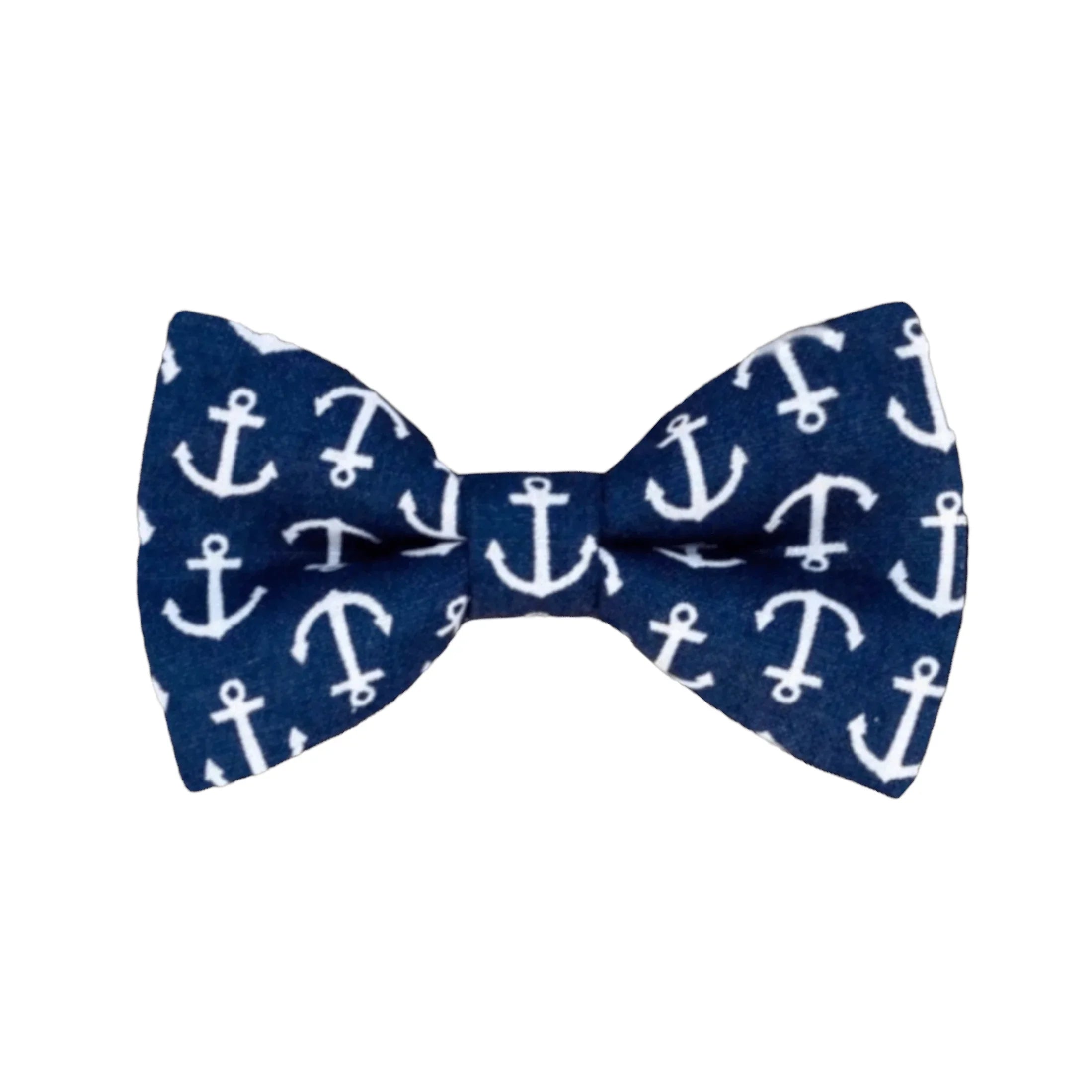 A navy blue cotton bow tie with white anchor patterns, designed for children and men, pre-tied.