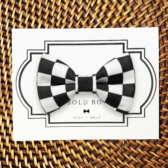 Black and white checkered bow tie displayed on a white card