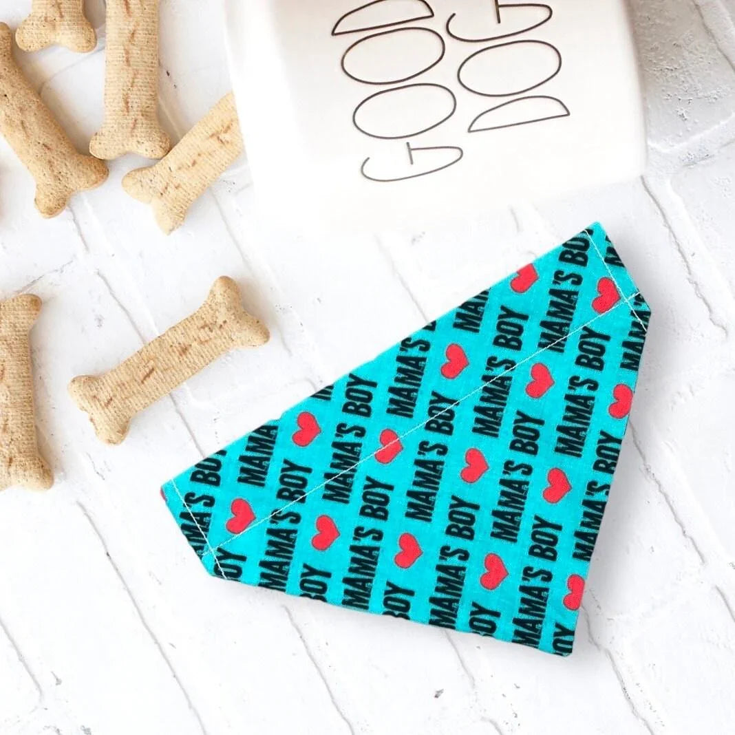 Size chart for dog bandanas from The Bold Bow Tie detailing measurements for Small, Medium, Large, and X-Large sizes. Small fits neck sizes 11 to 13 inches with a width of 7 inches and length of 5 inches. Medium fits neck sizes 13 to 16 inches with a width of 9 inches and length of 6 inches. Large fits neck sizes 16 to 21 inches with a width of 11 inches and length of 8 inches. X-Large fits neck sizes 21 to 25 inches with a width of 13 inches and length of 9 inches.