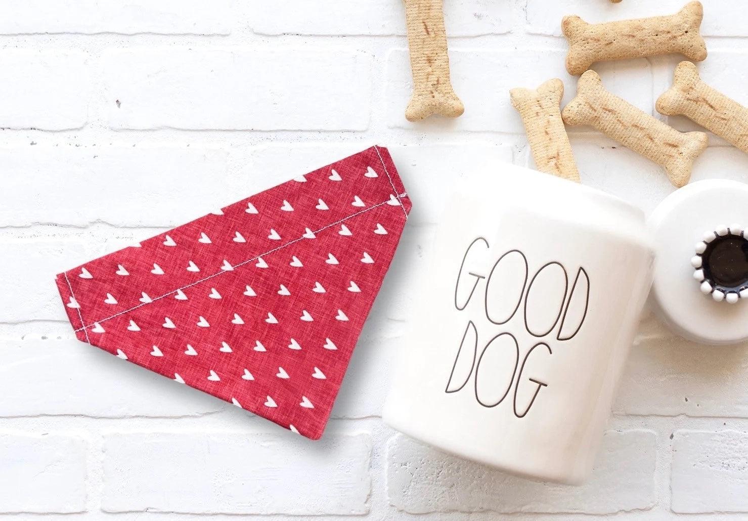 A Valentine’s Day dog bandana next to some dog treats