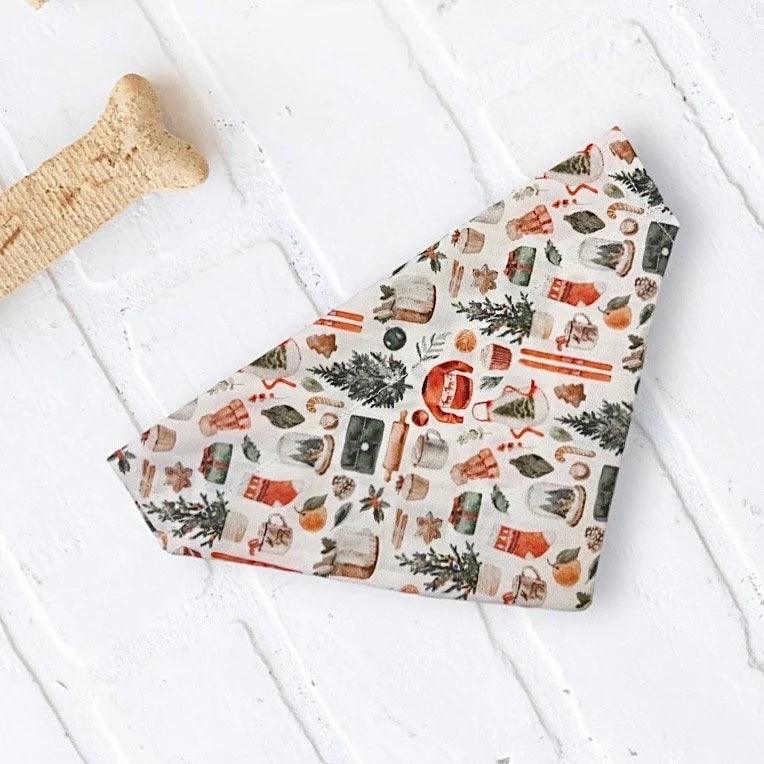 a Christmas dog bandana on a white background with a bone