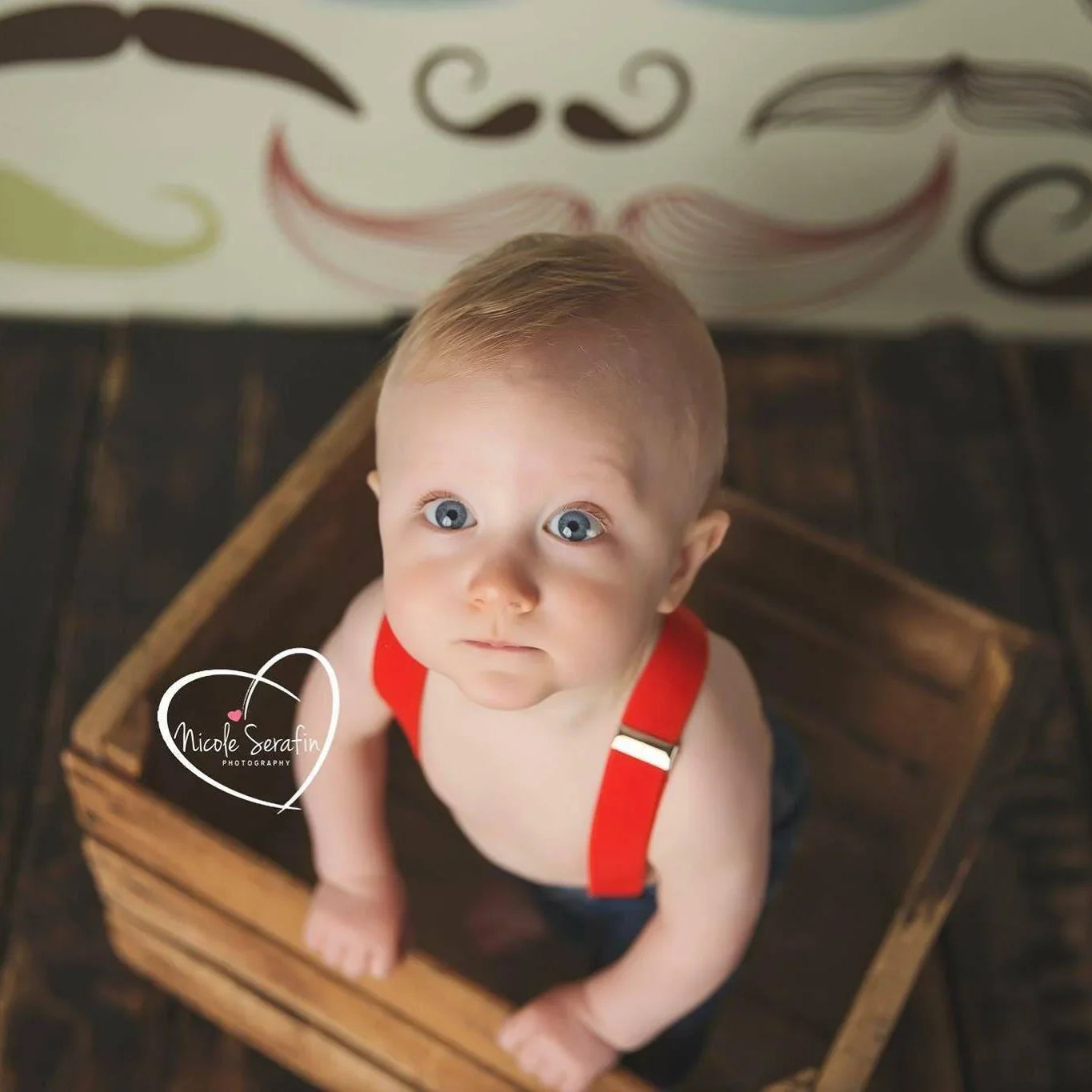 Toddler wearing red suspenders.