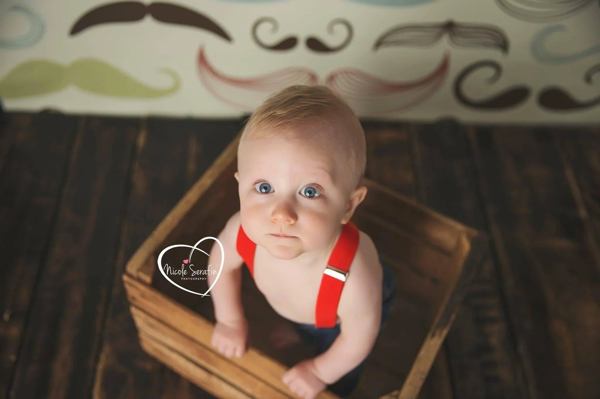 Toddler wearing red suspenders.