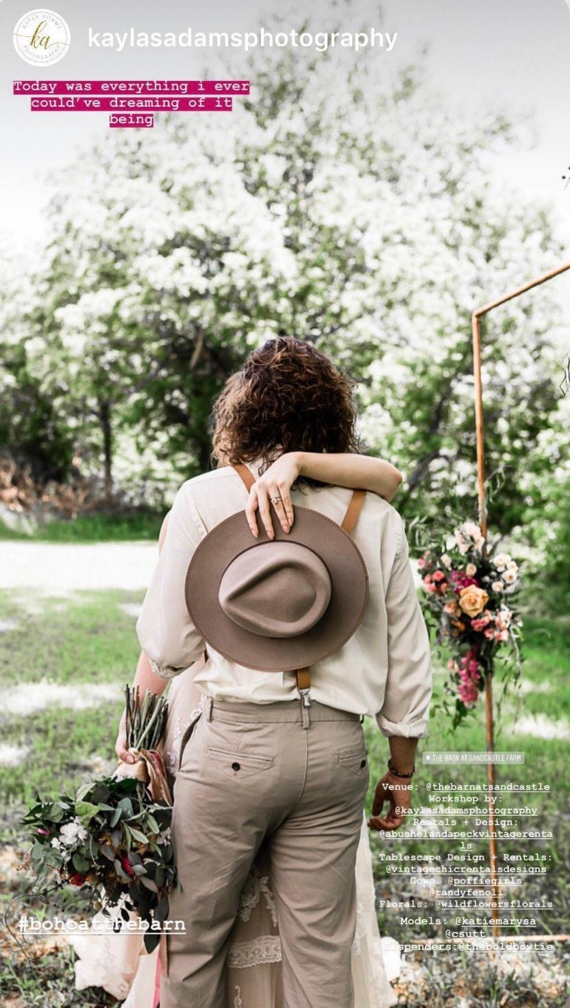 Back view of a person outdoors wearing taupe bow tie and tan vegan leather suspenders