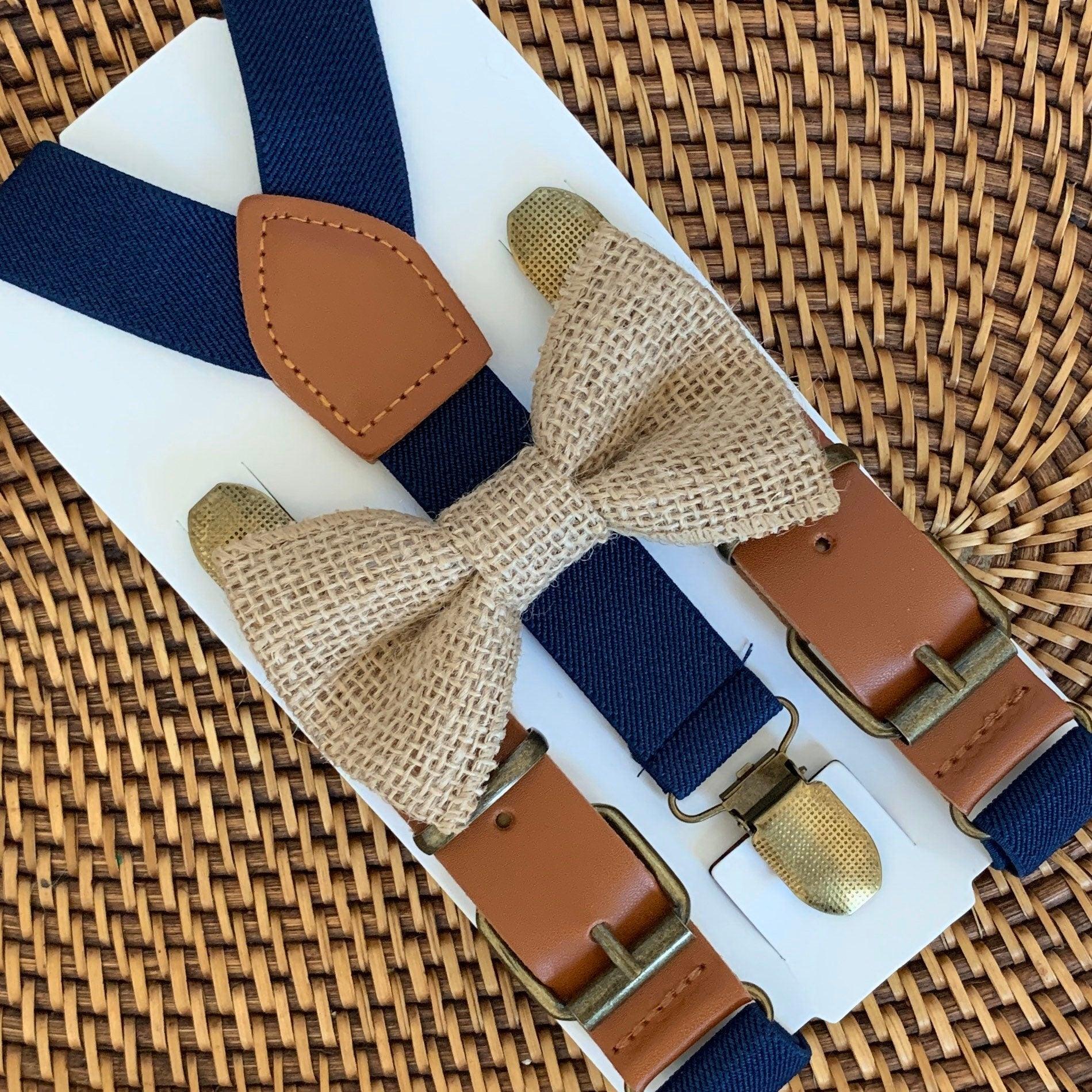 A cowboy chic burlap bow tie on rustic navy buckled suspenders for a cowboy wedding.