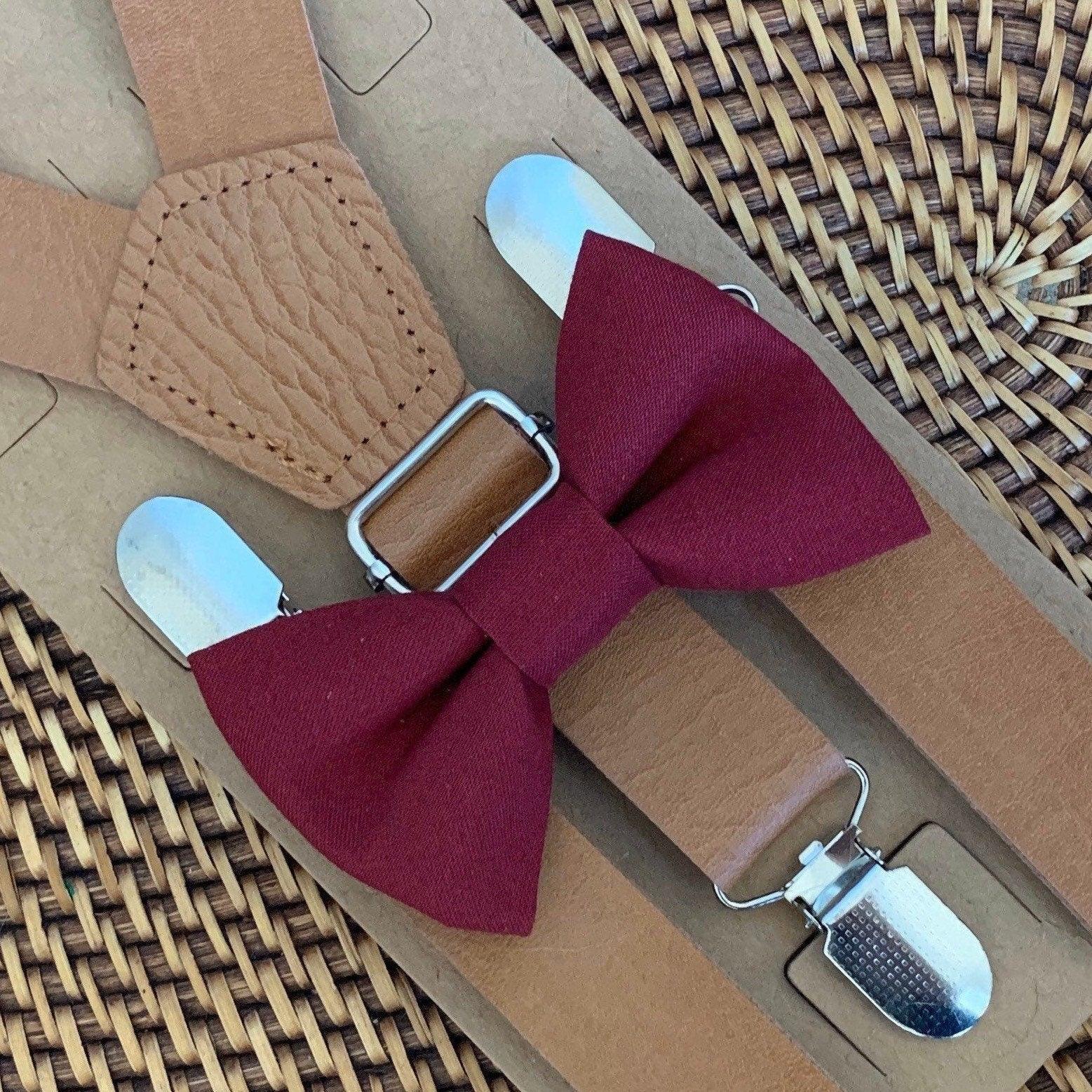 Burgundy bow tie with tan vegan leather suspenders displayed on kraft packaging