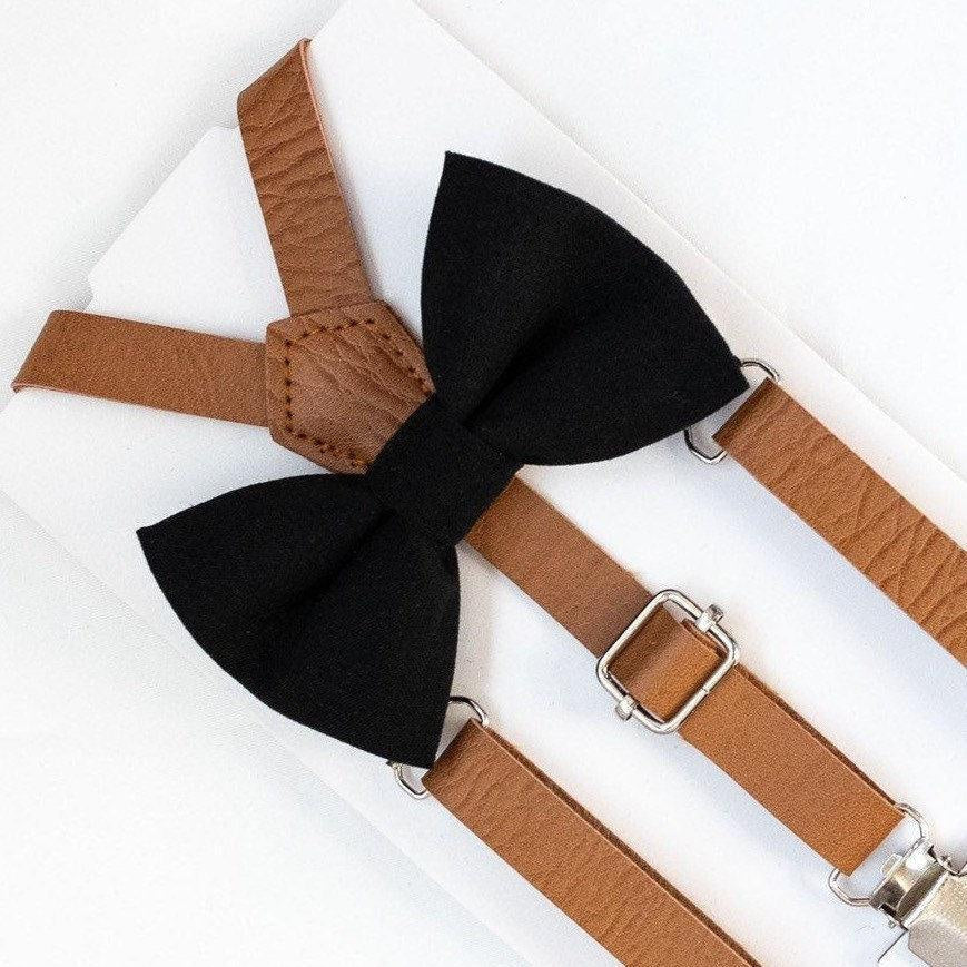 Black bow tie with brown suspenders on a white background