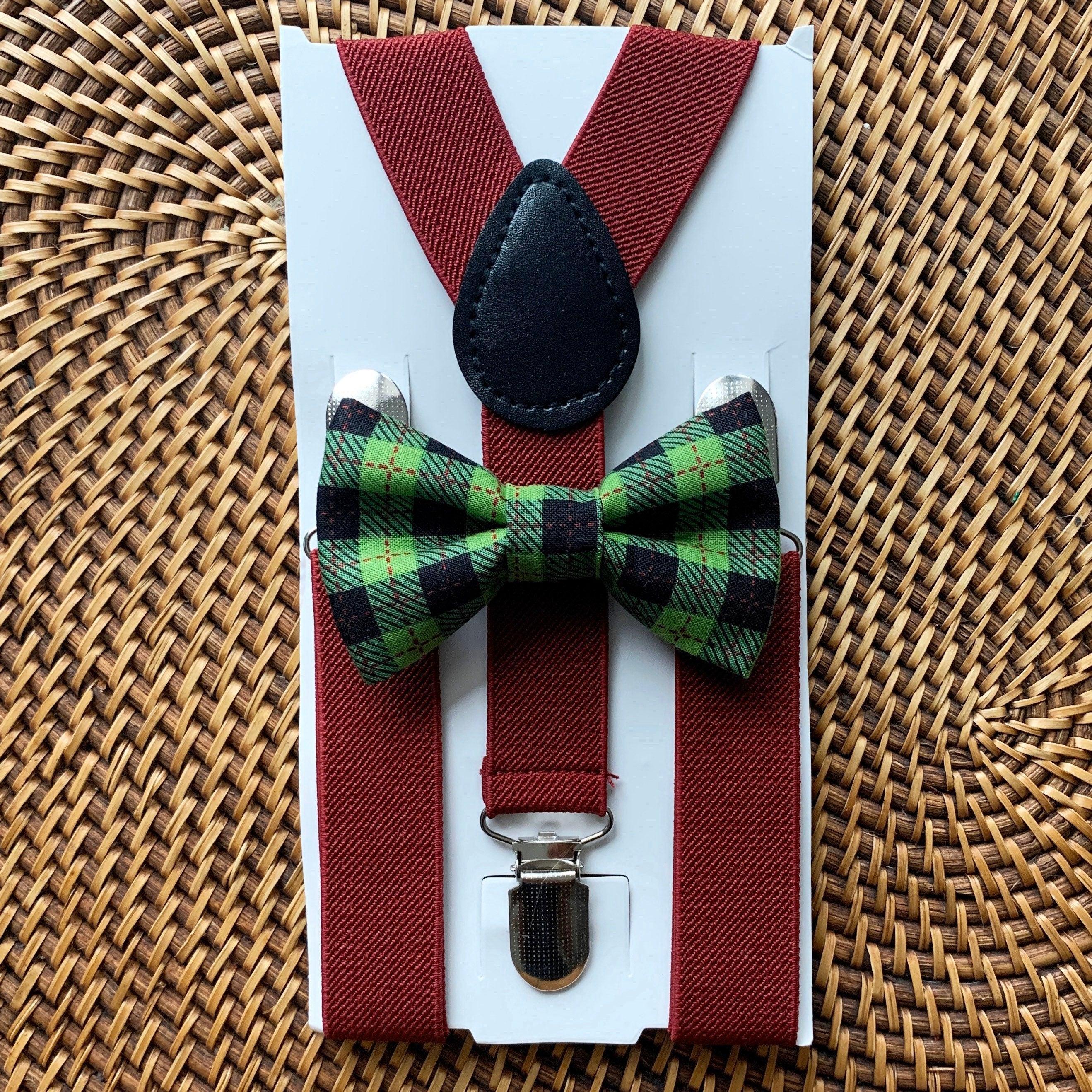 Green plaid bow tie and burgundy suspenders on a white display card.