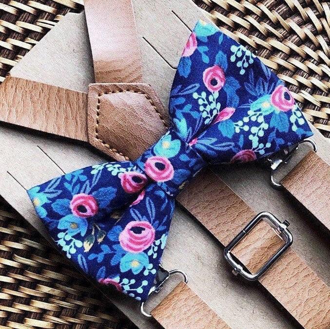 Floral bow tie and suspenders on a woven surface