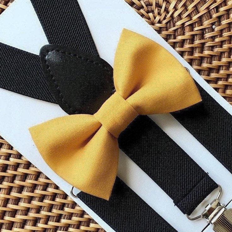 Yellow bow tie on a black and white striped background with a woven basket.