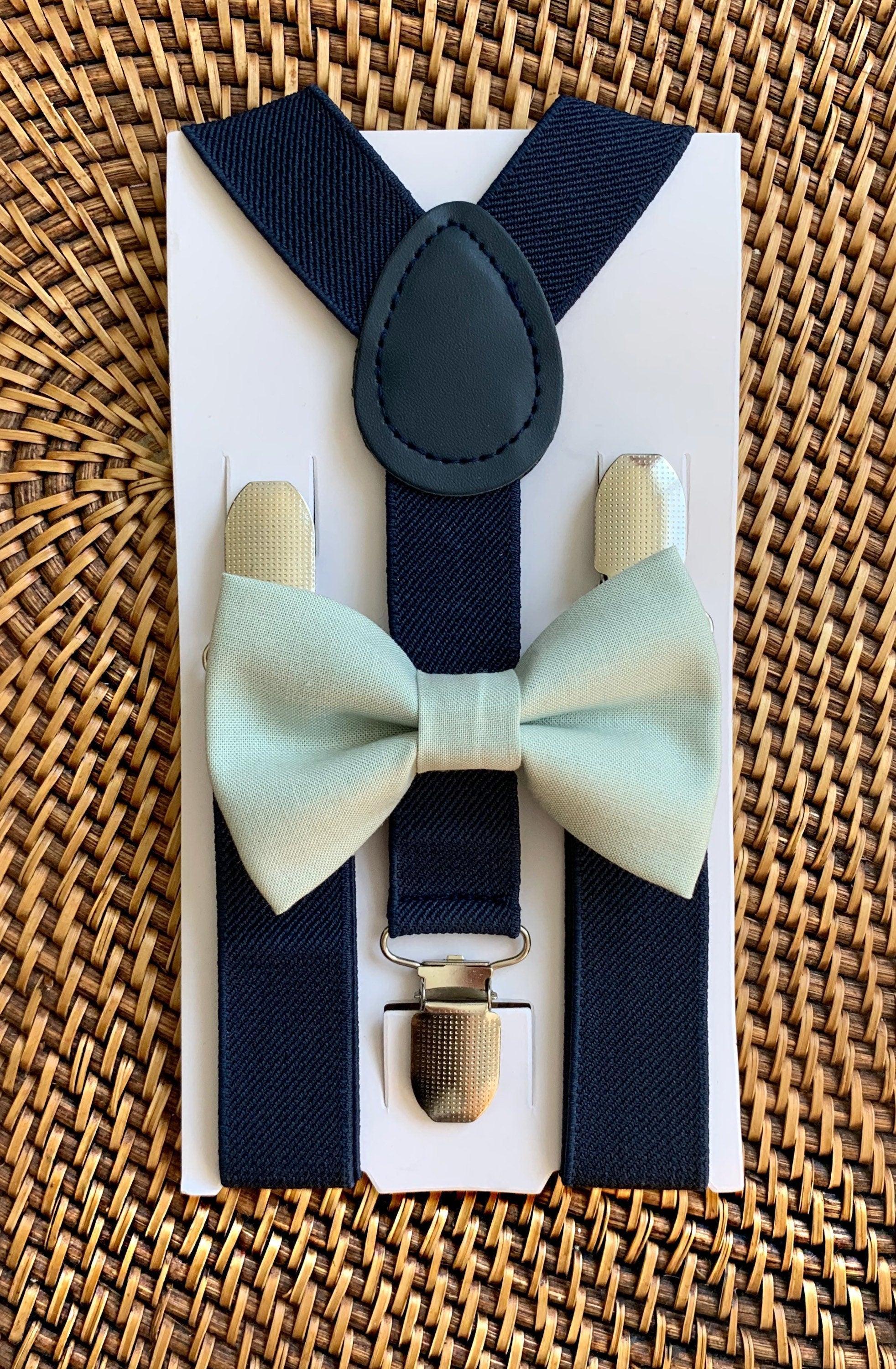 The Bold Bow Tie size chart for bow tie and suspender sets showing Small, Medium, Adult, and Big & Tall sizes with typical age ranges, suspender lengths, and bow tie widths. Small fits ages 6 months–6 years with 18–29 inch suspenders and a 3.5 inch bow tie; Medium fits ages 7–12 years with 25.5–40 inch suspenders and a 4 inch bow tie; Adult fits ages 13 years–6 feet tall with 25.5–40 inch suspenders and a 4.5 inch bow tie; Big & Tall fits over 6 feet tall with 31–53 inch suspenders and a 4.5 inch bow tie.