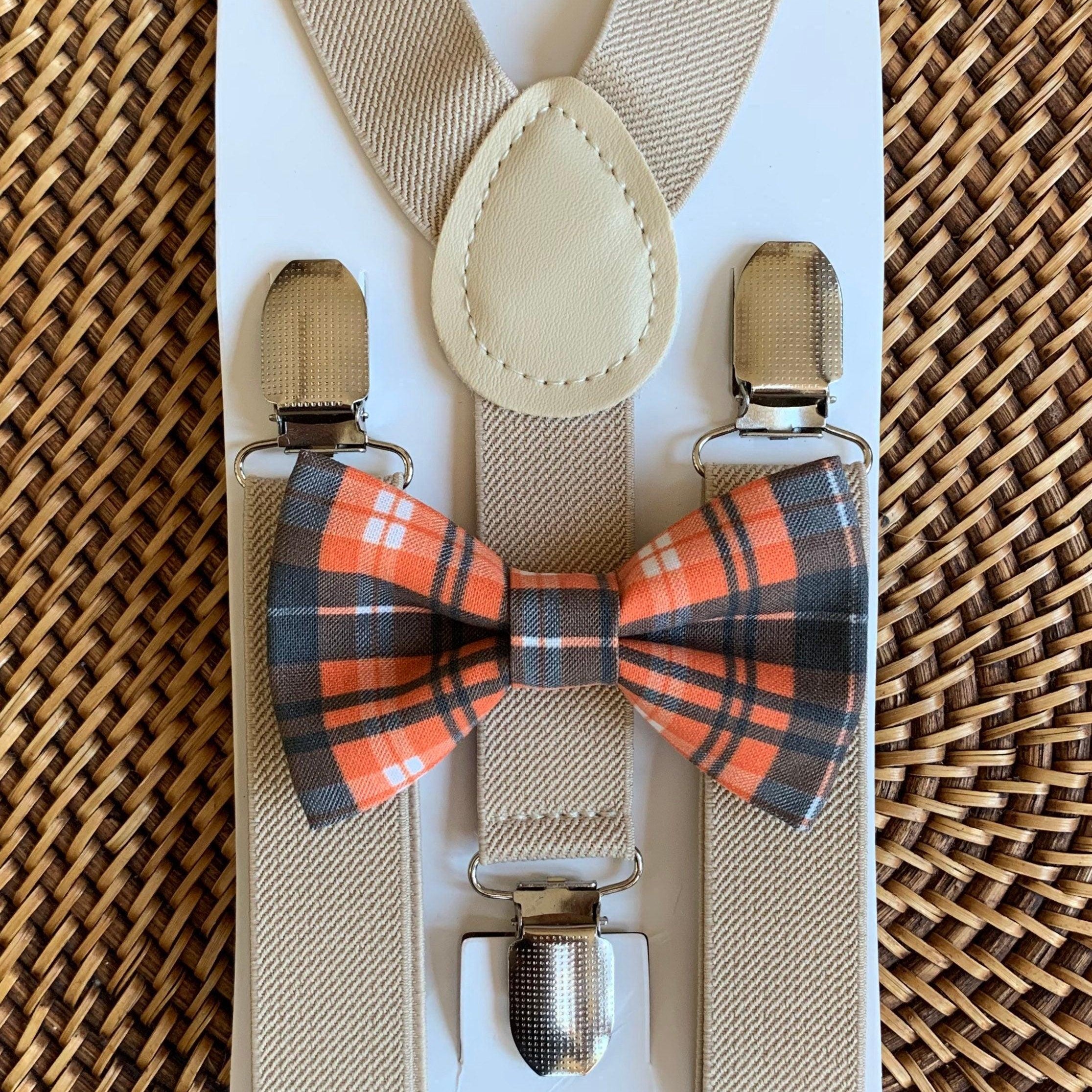 Orange and black plaid bow tie and tan suspenders.