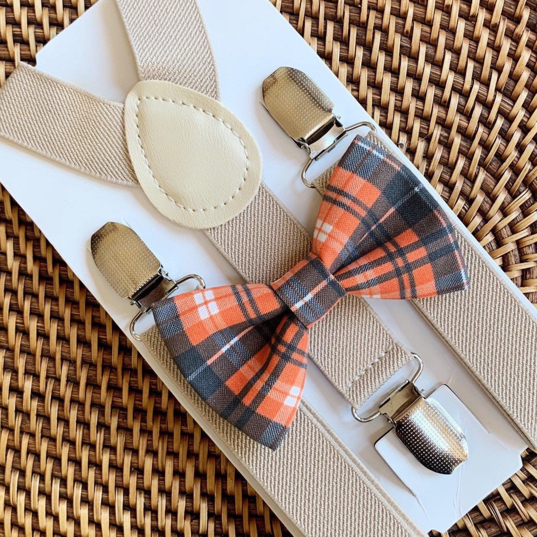 Orange and black plaid bow tie and tan suspenders.