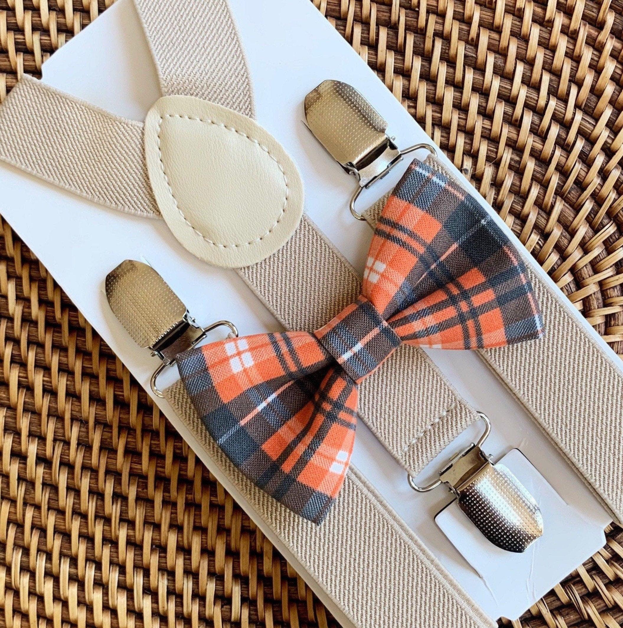 Orange and black plaid bow tie and tan suspenders.