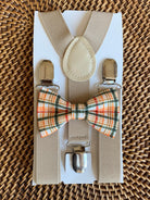Orange plaid bow tie and tan suspenders.