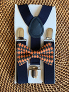 Black and orange checkered bow tie and navy suspenders.