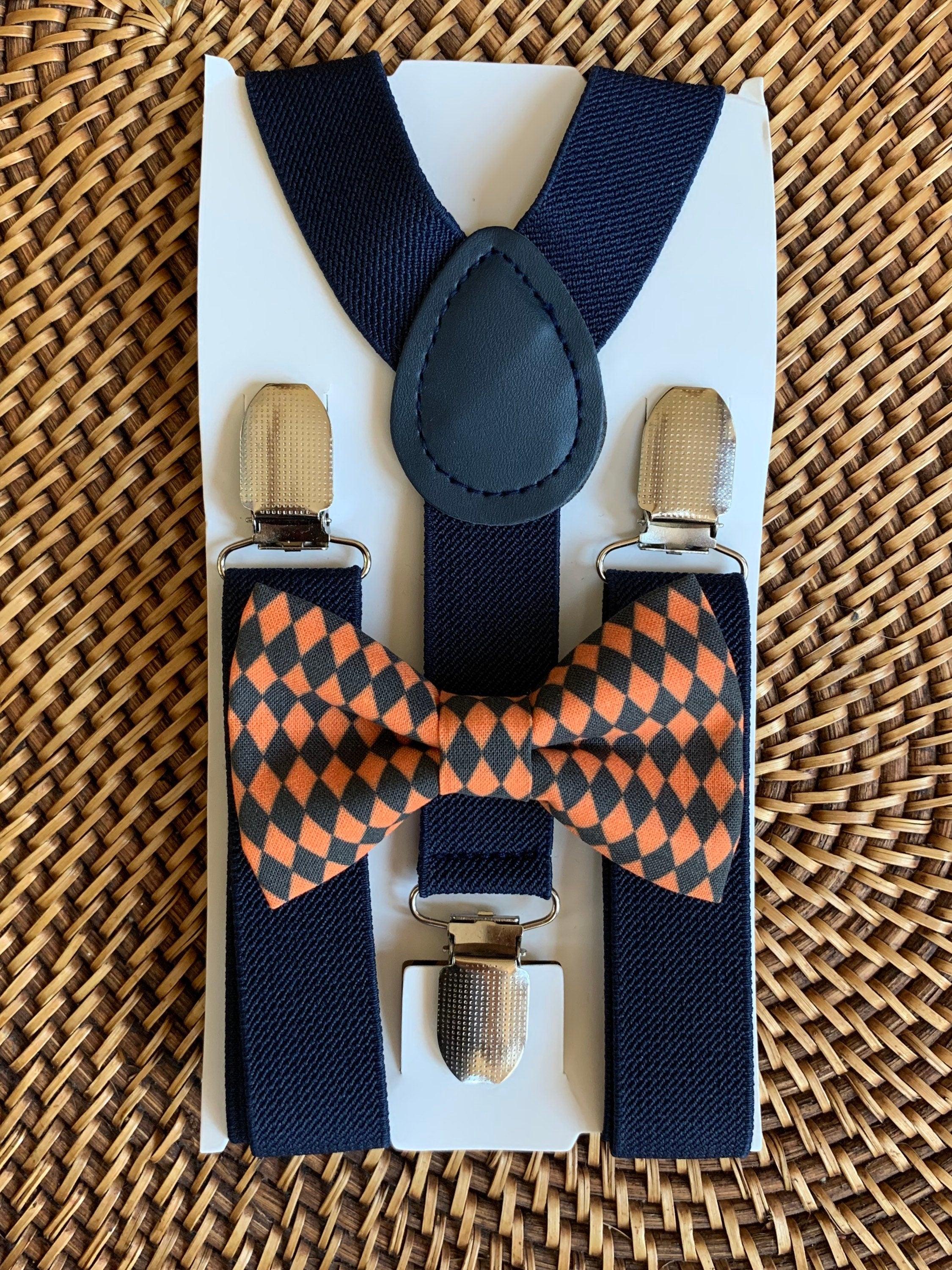 Black and orange checkered bow tie and navy suspenders.