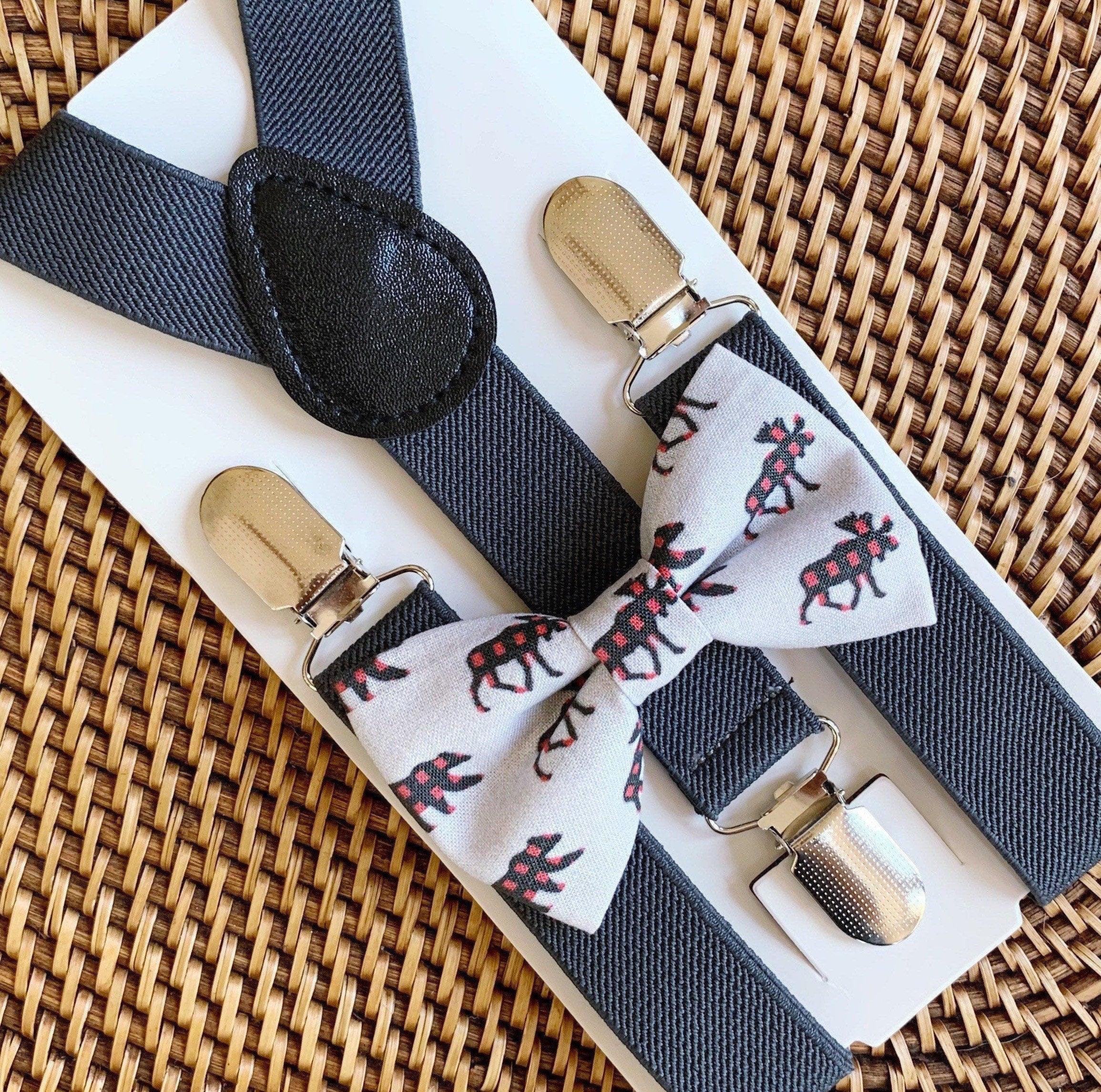 Gray suspenders with a bow tie featuring deer pattern on a woven surface