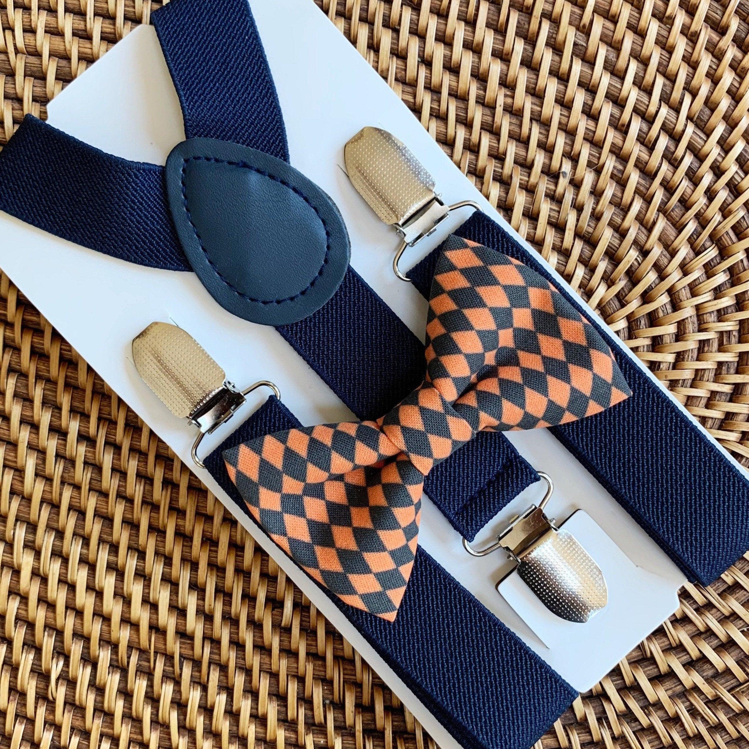 Black and orange checkered bow tie and navy suspenders.