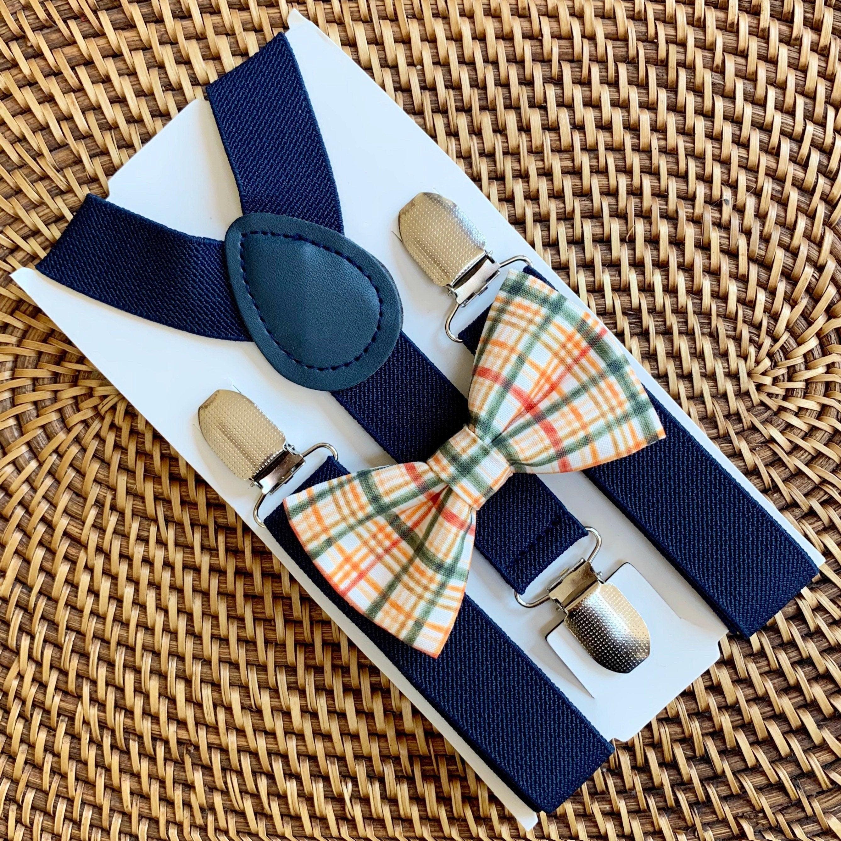 Orange checkered bow tie and navy suspenders.