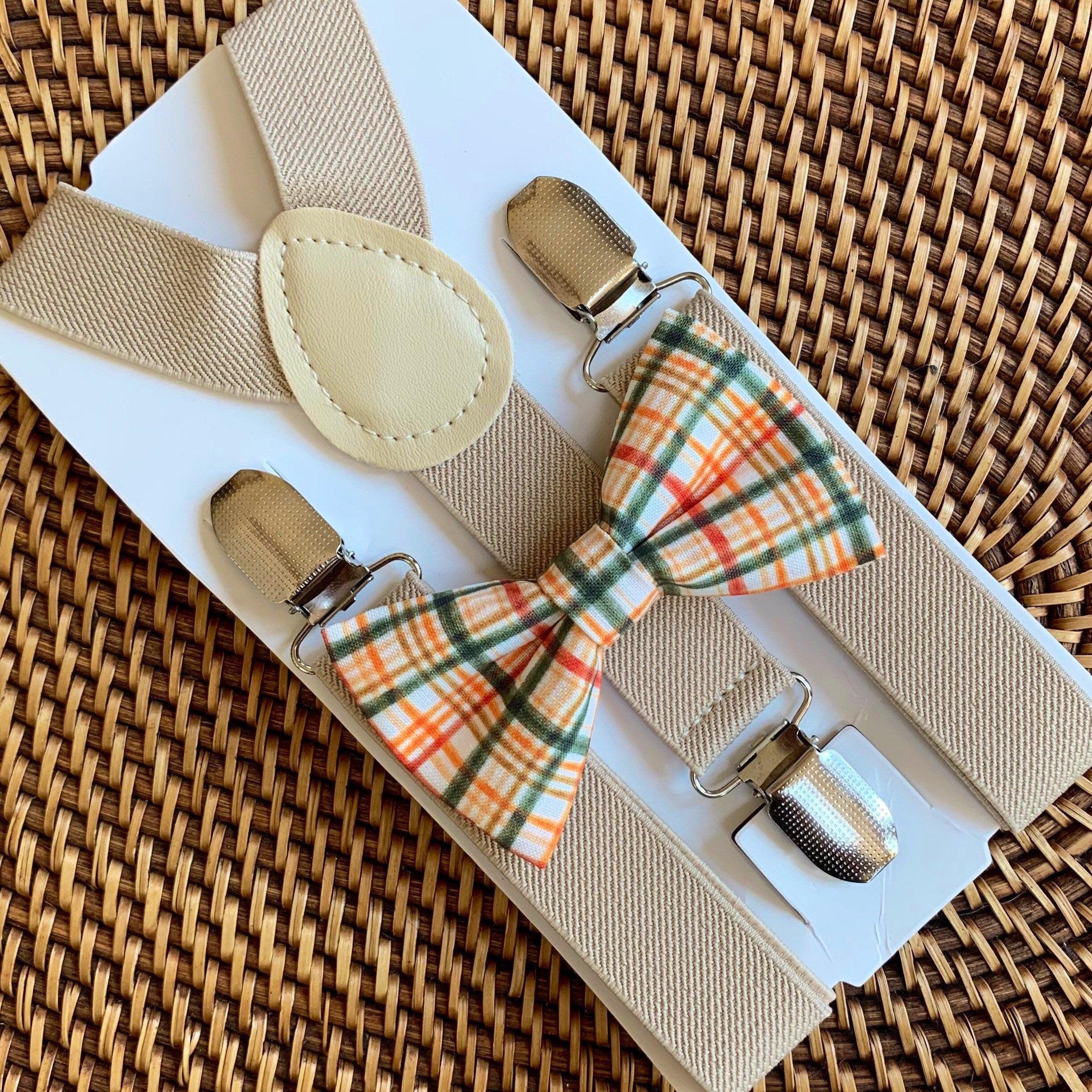 Orange plaid bow tie and tan suspenders.