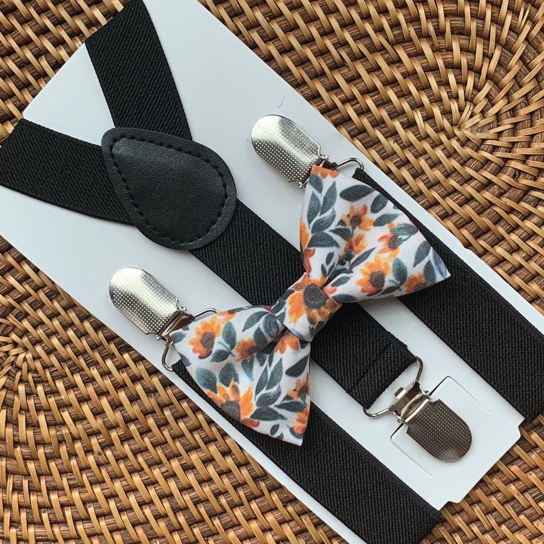 Sunflower bow tie with black suspenders arranged on a white display card