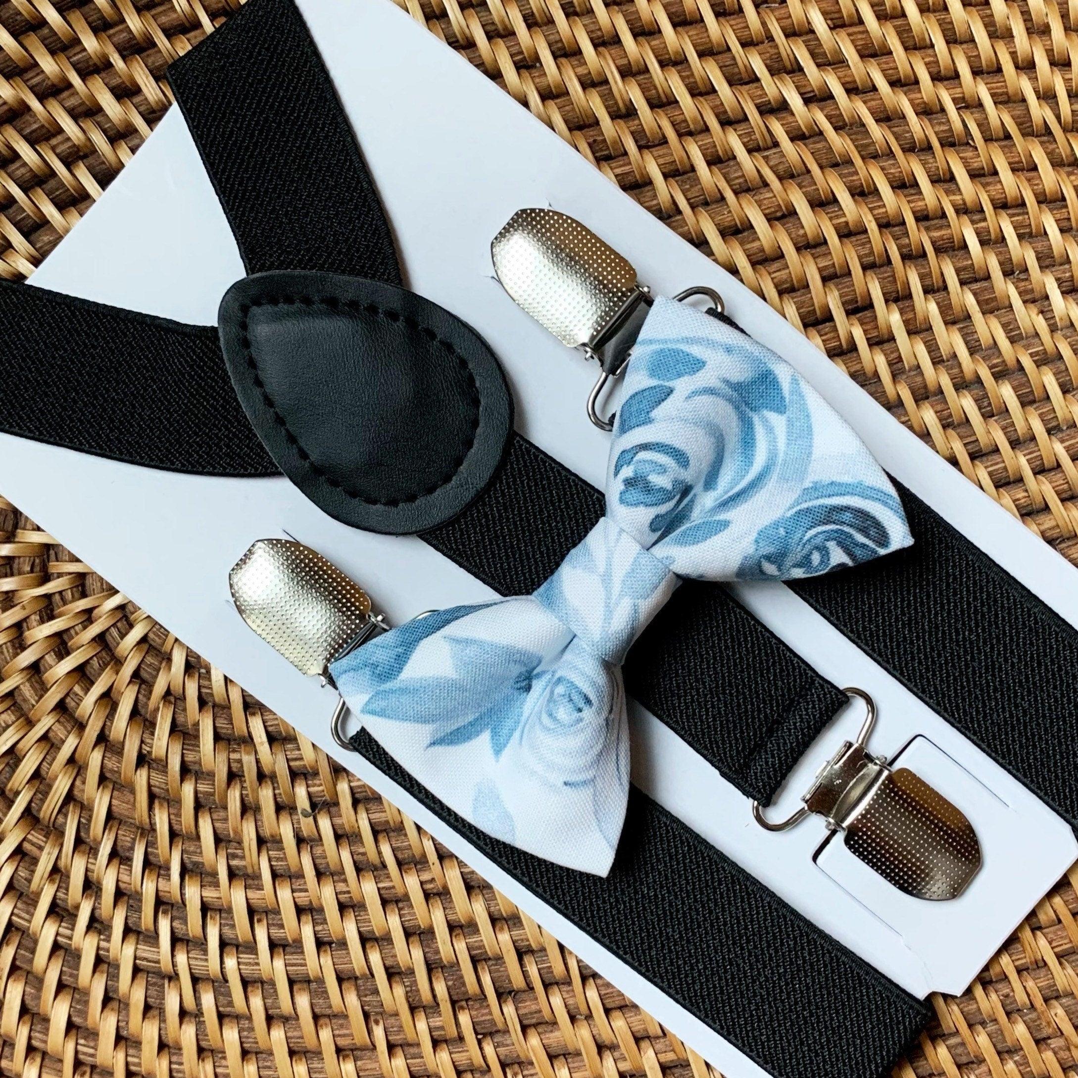 Bow Tie with blue and white floral print and black suspenders.