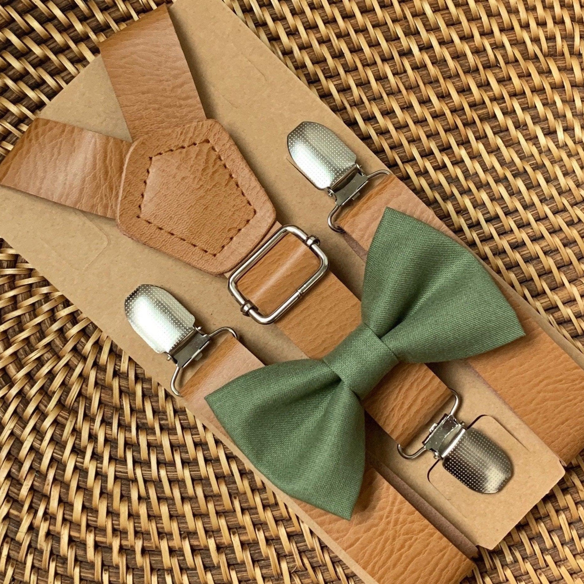 Olive bow tie with tan vegan leather suspenders and metal hardware on kraft backing