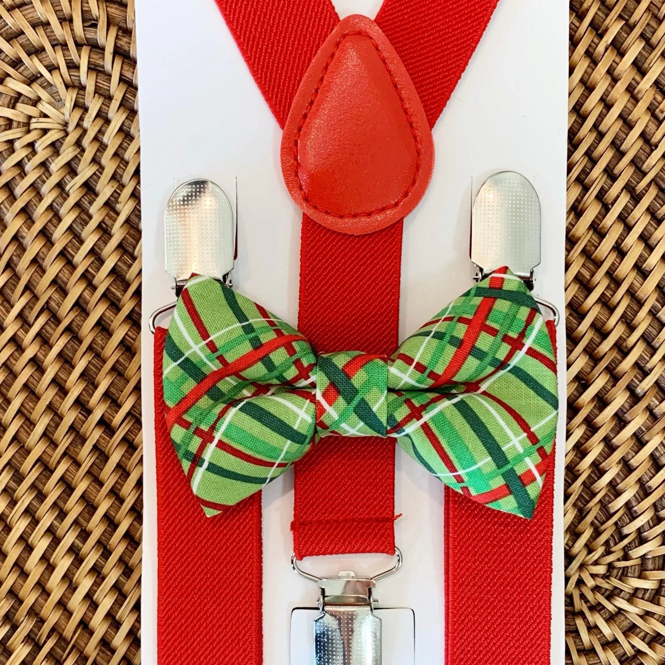 The Bold Bow Tie size chart for bow tie and suspender sets showing Small, Medium, Adult, and Big & Tall sizes with typical age ranges, suspender lengths, and bow tie widths. Small fits ages 6 months–6 years with 18–29 inch suspenders and a 3.5 inch bow tie; Medium fits ages 7–12 years with 25.5–40 inch suspenders and a 4 inch bow tie; Adult fits ages 13 years–6 feet tall with 25.5–40 inch suspenders and a 4.5 inch bow tie; Big & Tall fits over 6 feet tall with 31–53 inch suspenders and a 4.5 inch bow tie.