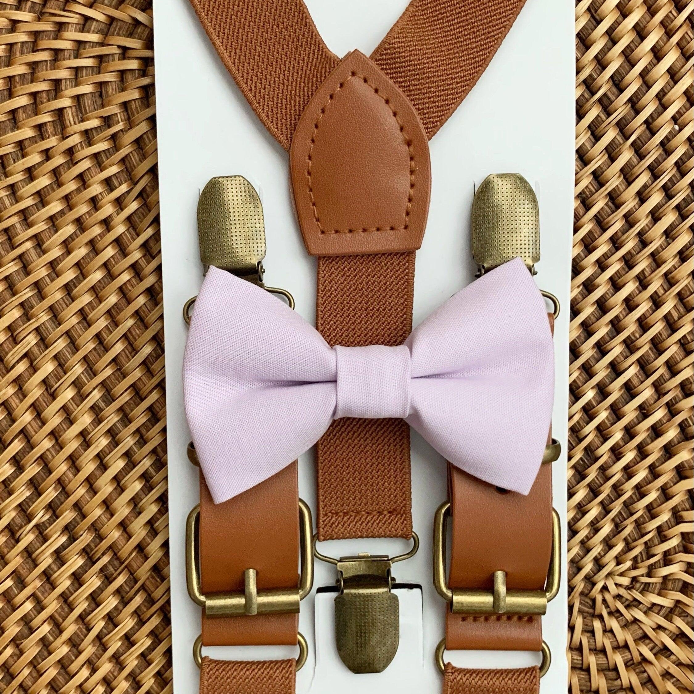 Size chart for suspender and bow tie sets from The Bold Bow Tie. X-Small (6mo-4yr): 15"-23" suspenders, 3.5" bow. Small (5-9yr): 18"-33" suspenders, 3.5" bow. Medium (10-12yr): 18"-33" suspenders, 4" bow. Adult (13yr-6'5"): 30"-53" suspenders, 4.5" bow. Big & Tall (Over 6'5"): 53"+ suspenders, 4.5" bow. Instructions note to measure from the back waistband over the shoulder to the front waistband for a comfortable fit.