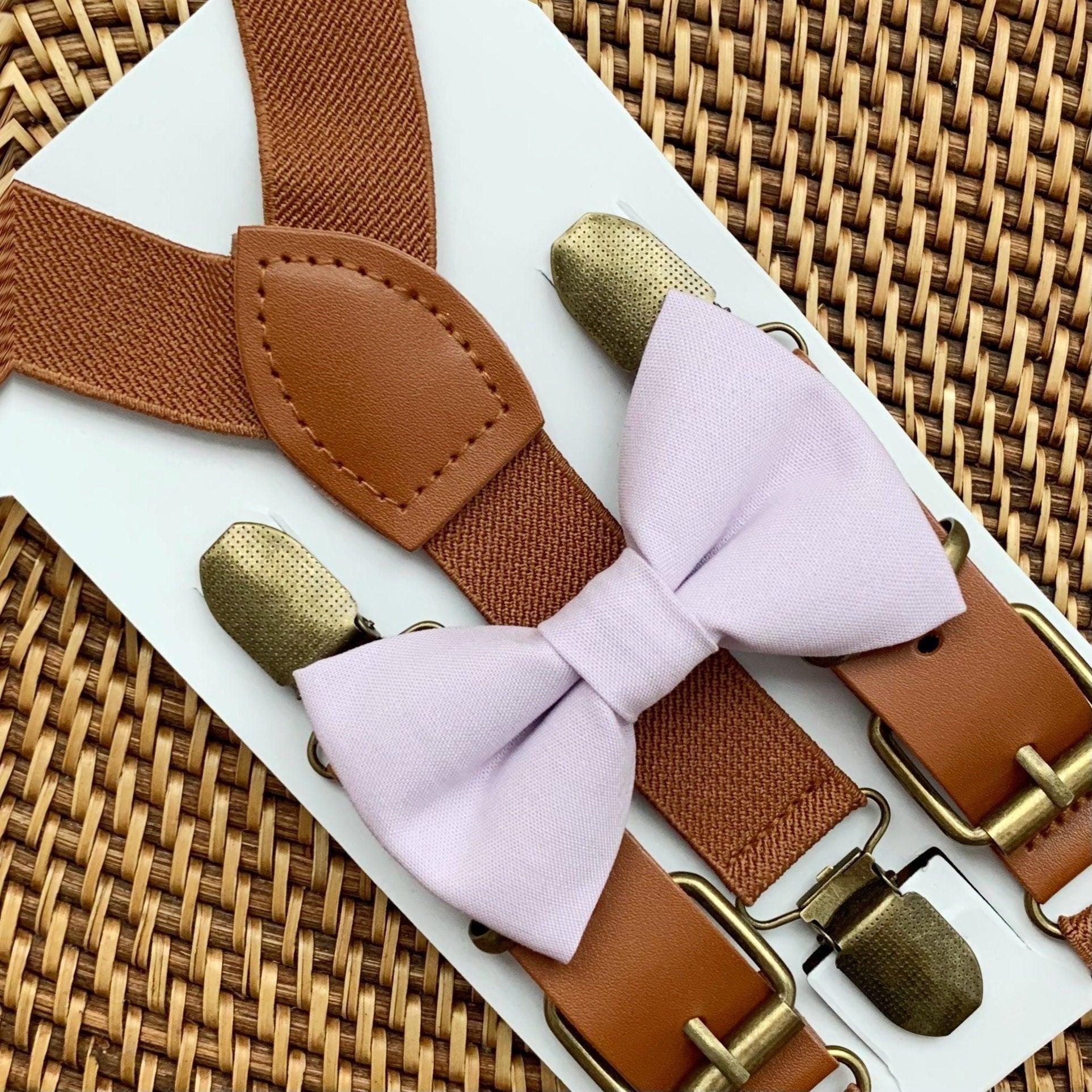 Iris Bow Tie and Cognac Buckle Suspenders set with brown textured straps and tan leather patch displayed on a white card.